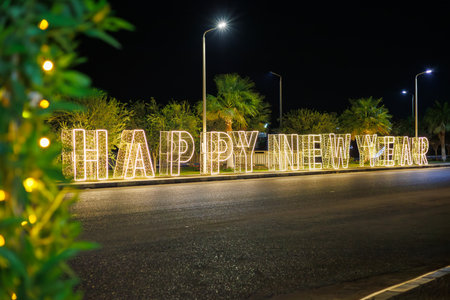Illuminated happy New Year sign on street.の写真素材