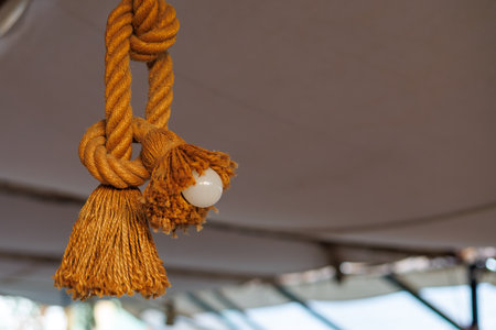 Decorative braided rope light fixture with tassels.の写真素材