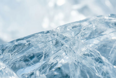 Close-up of fractured ice surface with light.の素材