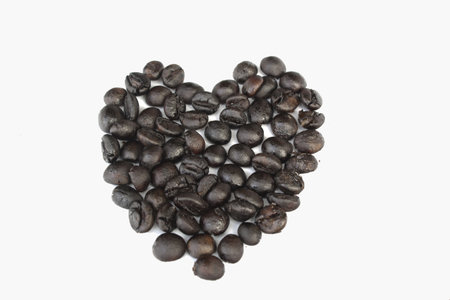 roasted coffee beans in the shape of the heart. の写真素材