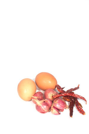 Egg, red onion, dried peppers for cooking.の写真素材
