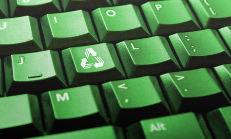 Green computer keyboard with recycle logo on one of the keysの写真素材