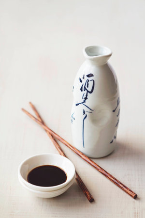 White japanese bottle and background with sauce bowl and chopsticksの写真素材