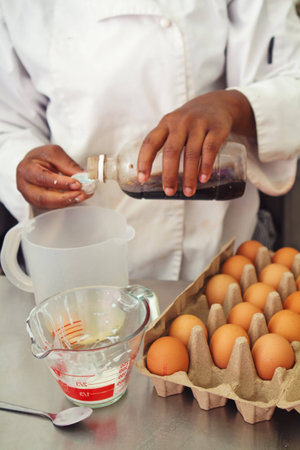 Pastry chef measuring ingredients for a cake bakingの写真素材