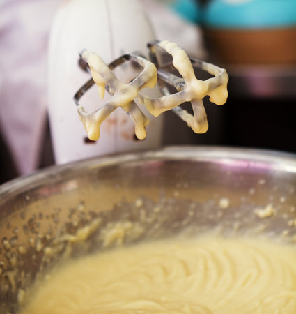 Close up of hand mixer beaters with cake mix drippingの写真素材