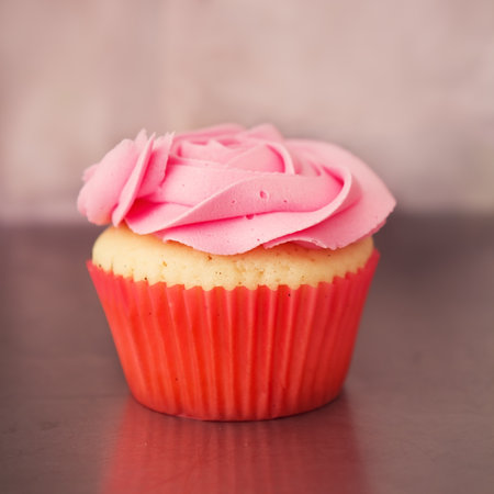 Single pink rose cupcake with blurred backgroundの写真素材