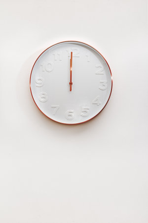 Modern copper and white decorative wall clock on a white wallの写真素材