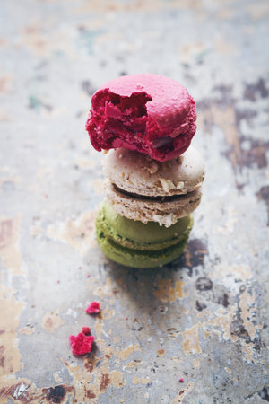 Stack of three yummy macaroons on rustic  table backgroundの写真素材