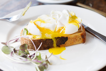 Gourmet poached free range eggs on toast with dripping yolk