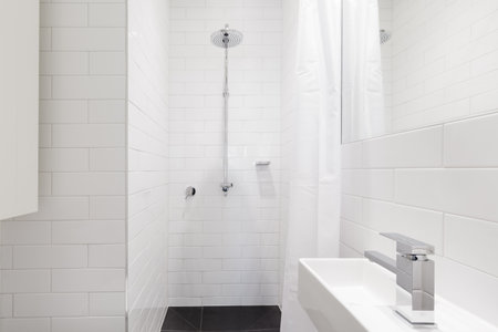 Horizontal verion of crisp white ensuite bathroom in renovated homeの写真素材