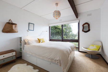 Retro styled guest bedroom in a 70s beach house shack