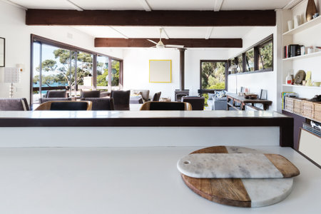 Kitchen bench looking to open plan living room in retro beach homeの写真素材