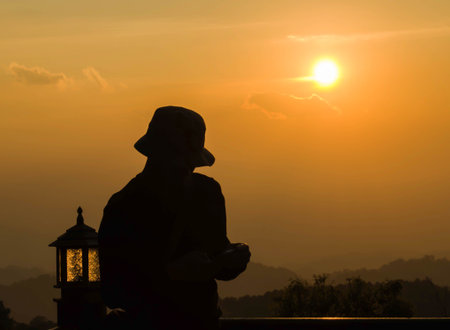 A silhouette man chatting in the sunset time in the evening.の写真素材