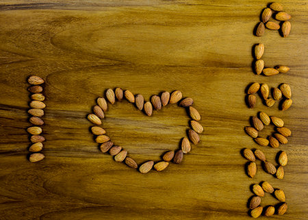 The word is I Love Almonds on the wood table backgroundの写真素材