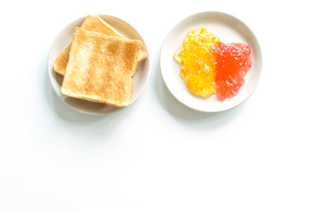 A bread with pineapple and strawberry jam isoated on white background.の写真素材