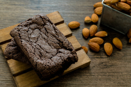 The Chocolate Brownie with Almonds and Coffee on the pallet wood has ready to served in the dessert time.の写真素材