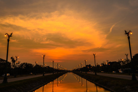 Sunset over a highway Utthayan Road and reflection on the river in Bangkok Thailand.の写真素材