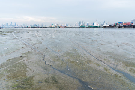 Transportation on the dirty sea with building city background and cloudy sky in Bangkok Thailand.