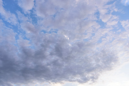 Cloudy sky group with condensation in evening before sunset and raining.