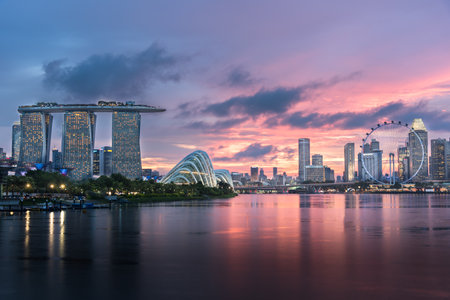 MARINA BAY SANDS, SINGAPORE - May 24, 2017: Marina Bay Sands and Singapore Flyer view from Marina Barrage with waterfront reflection on sunset time at Marina Bay Sands Singapore.のeditorial素材