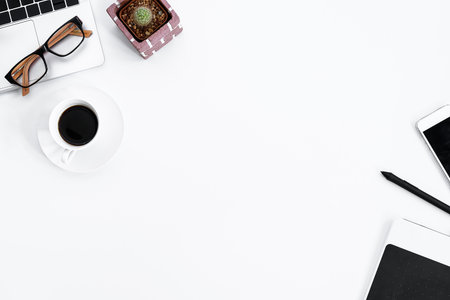 Graphic Designer white work table with computer, cactus, coffee, phone and pen for hard work in the morning with top view. Desk top view concept.の写真素材