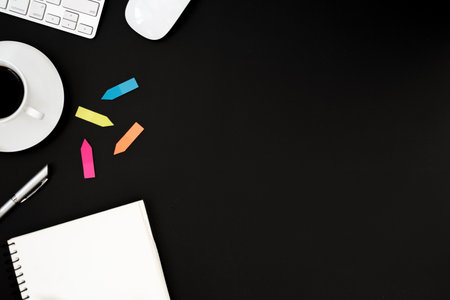 Office desk table with computer, white mouse, silver pen, multi color post-it and black coffee cup....
