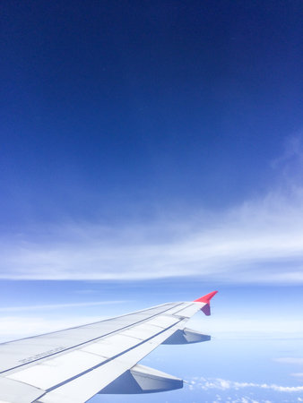 Morning blue sky with Wing of an airplane.