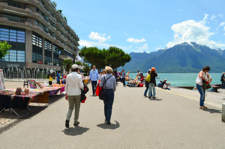 Editorial: Switzerland, 14th July 2012. Tourists relaxing on vacation and holiday at Switzerland with mountain and sea background.のeditorial素材