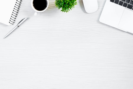 White wood office desk table and equipment for working with black coffee  in top view and flat ray concept.の写真素材