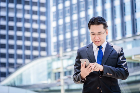 The asian businessman has working on mobile with happy.の写真素材