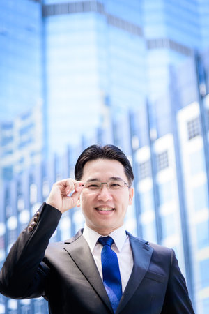 The asian businessman has thinking of vision with building and city background.の写真素材