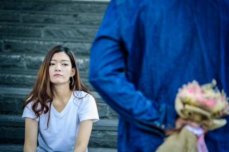 Asian beautiful woman has looking and waiting  for word of sorry from her boyfriend.の写真素材