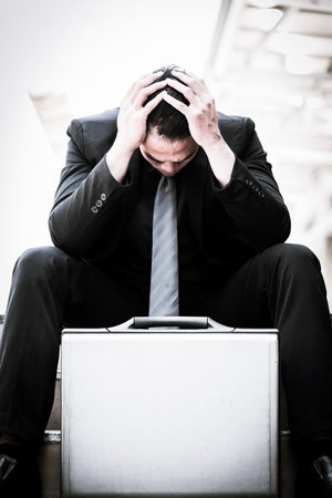 Asian Businessman feel sad and frustrated upset fail in life.の写真素材