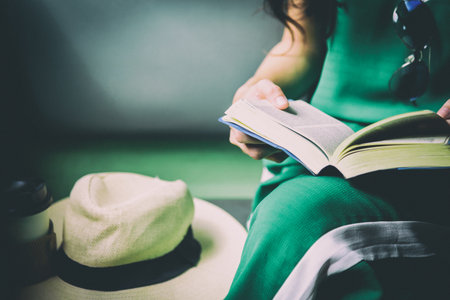 Asian woman traveler has reading a book in the train with happiness at Hua Lamphong station at Bangkok, Thailand.の写真素材