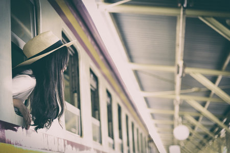 Asian woman traveler has get in the train with happiness at Hua Lamphong station at Bangkok, Thailand.の写真素材