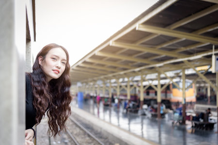 Asian woman traveler has exciting with traveling by train at Hua Lamphong station at Bangkok, Thailand.の写真素材