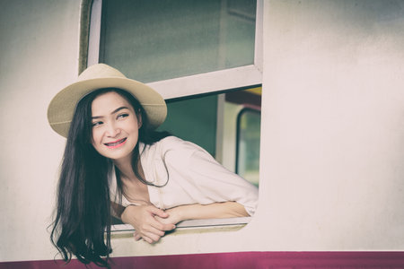 Asian woman traveler has get in the train with happiness at Hua Lamphong station at Bangkok, Thailand.の写真素材