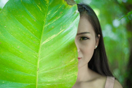 Asian pretty girl has closing right eye with close up concept at Little Tree Garden cafe, Nakhon...
