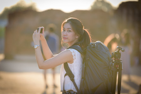Asian beautiful girl has travel and take a photo at Wat Chaiwatthanaram temple in Ayuthaya,...