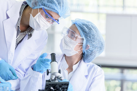 Asian scientist team has researching in laboratory.