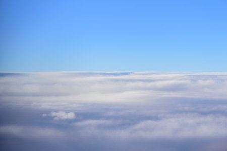 The blue skyline with cloudy in sunrise time, view from window on the plane.
