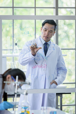 Asian scientist team has researching in laboratory.