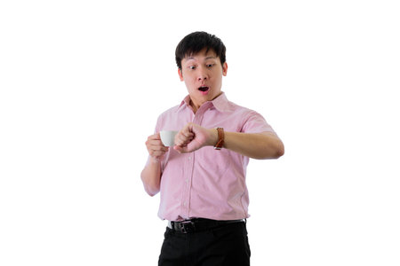Asian young businessman has standing and check working time with shocked on isolated on wihte background.の写真素材