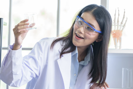 Asian young girl student scientist researching  and learning in a laboratory.の写真素材