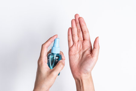 The Asian girl has cleaning hand by hand cleaner gel to protect COVID-19 with isolated on white...