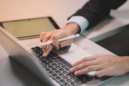 The Communication technology on laptop computer and tablet. Business man working and meeting using...
