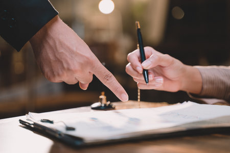 Businessman making agreement at office. it's a contract paper. Human hand holding pen mystery...