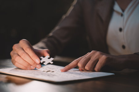 Close-up of business hands connecting jigsaw puzzle, success and goal achievement, the last jigsaw is the link of all the pieces. strategic planning or a solution for the management.の写真素材