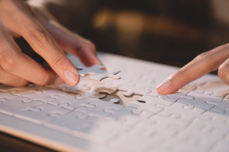 Close-up of business hands connecting jigsaw puzzle, success and goal achievement, the last jigsaw is the link of all the pieces. strategic planning or a solution for the management.の写真素材