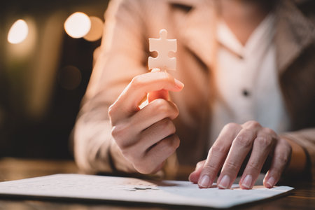 Close-up of business hands connecting jigsaw puzzle, success and goal achievement, the last jigsaw is the link of all the pieces. strategic planning or a solution for the management.の写真素材